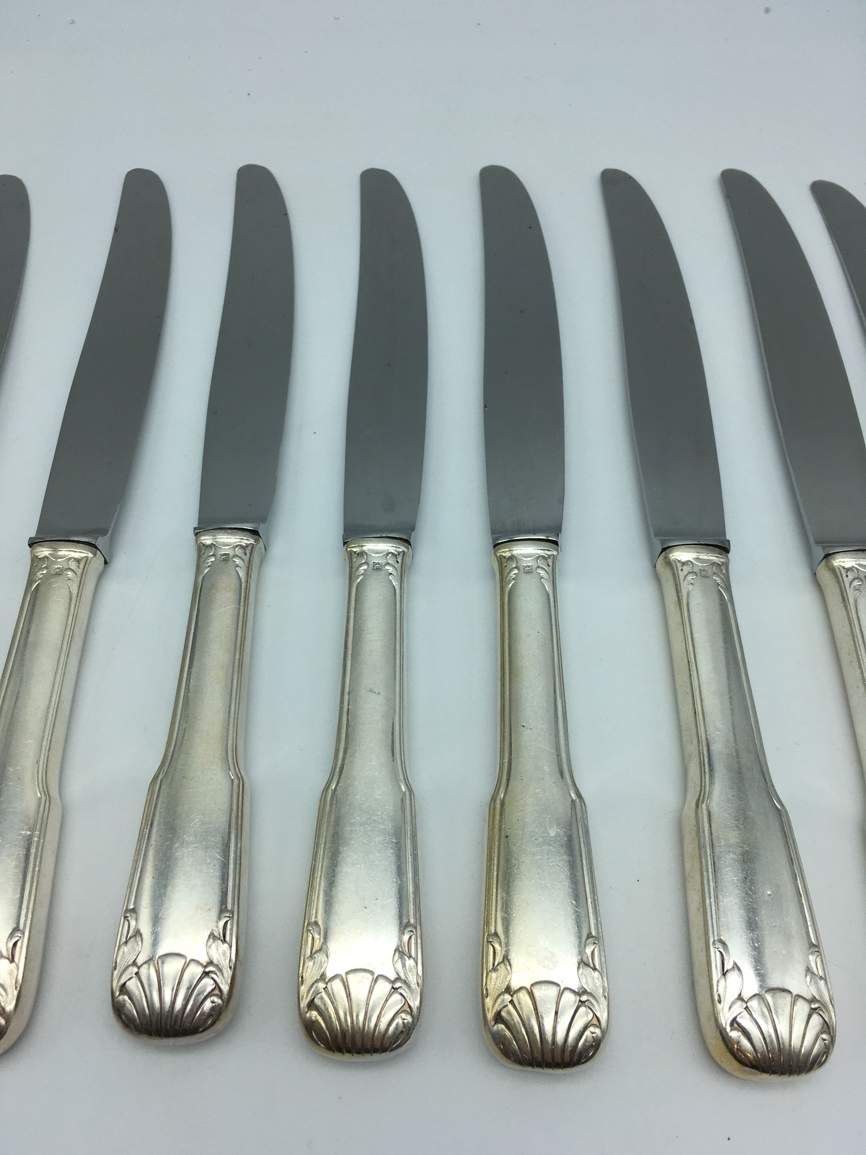 12 silver metal knives.