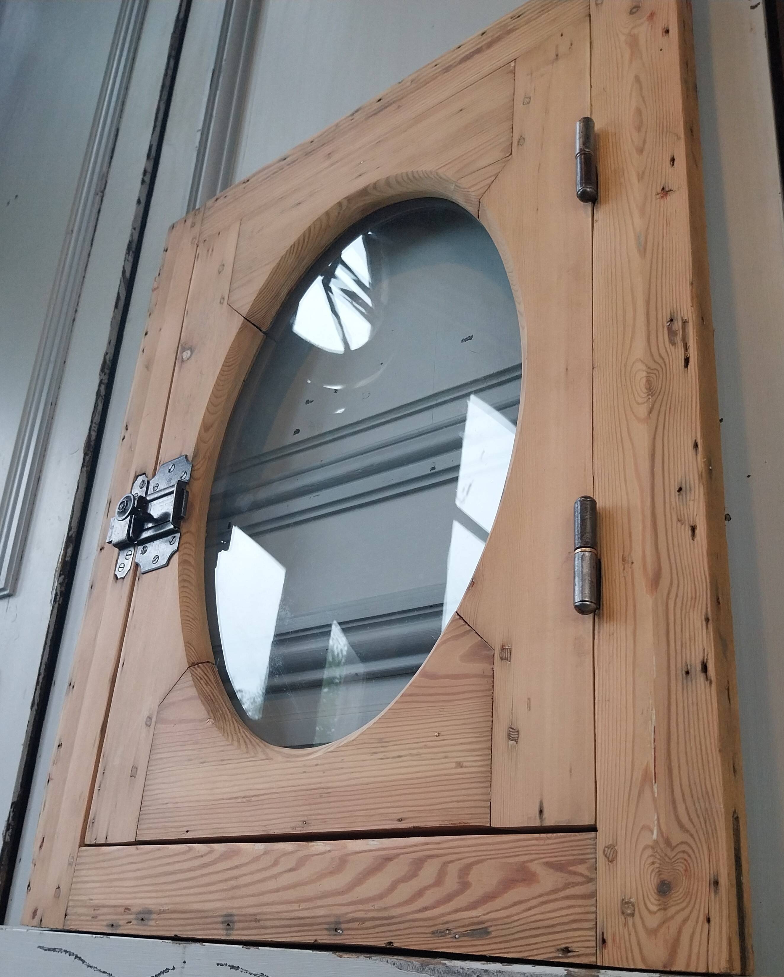 Old bullseye window with oval glass