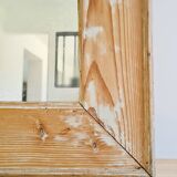 Antique mirror in raw wood with a patina and pediment.