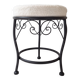 Black iron stool/pouf with its boucle fabric cushion.
