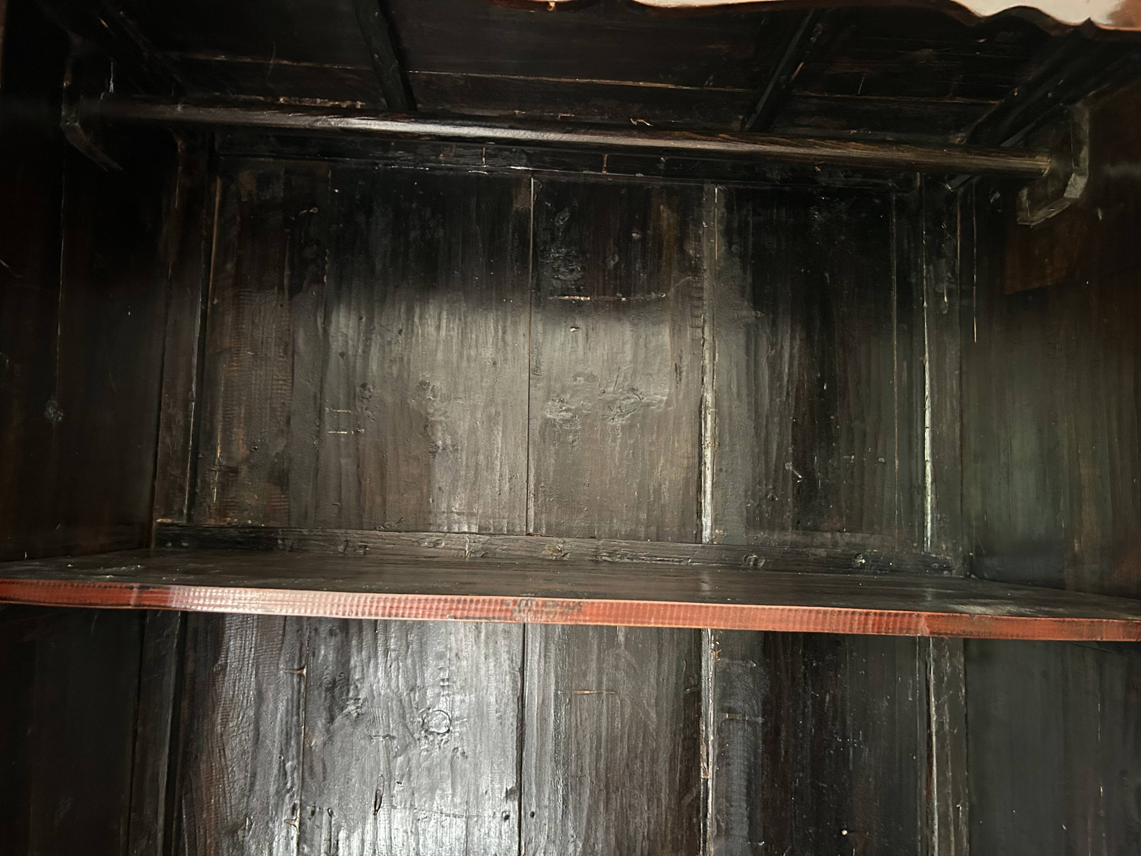 Antique Chinese wardrobe in carved elm.