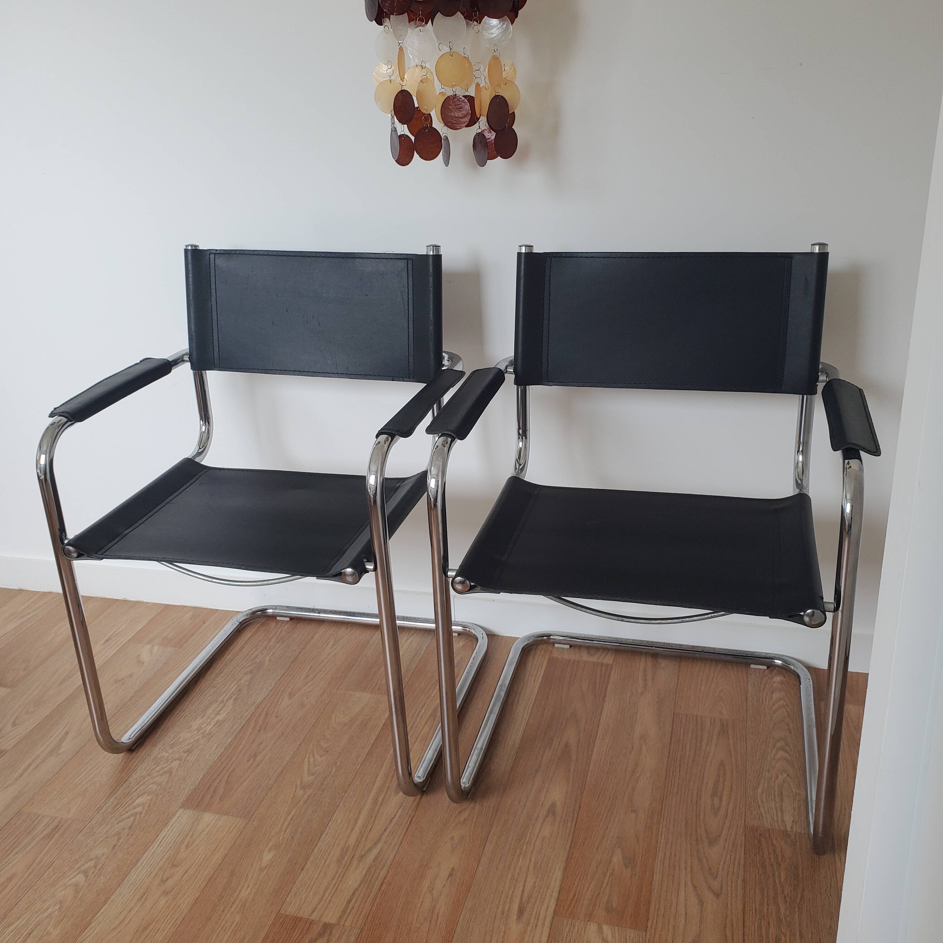 Pair of armchairs in chrome and black leather