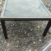 Vintage metal coffee table with glass top.