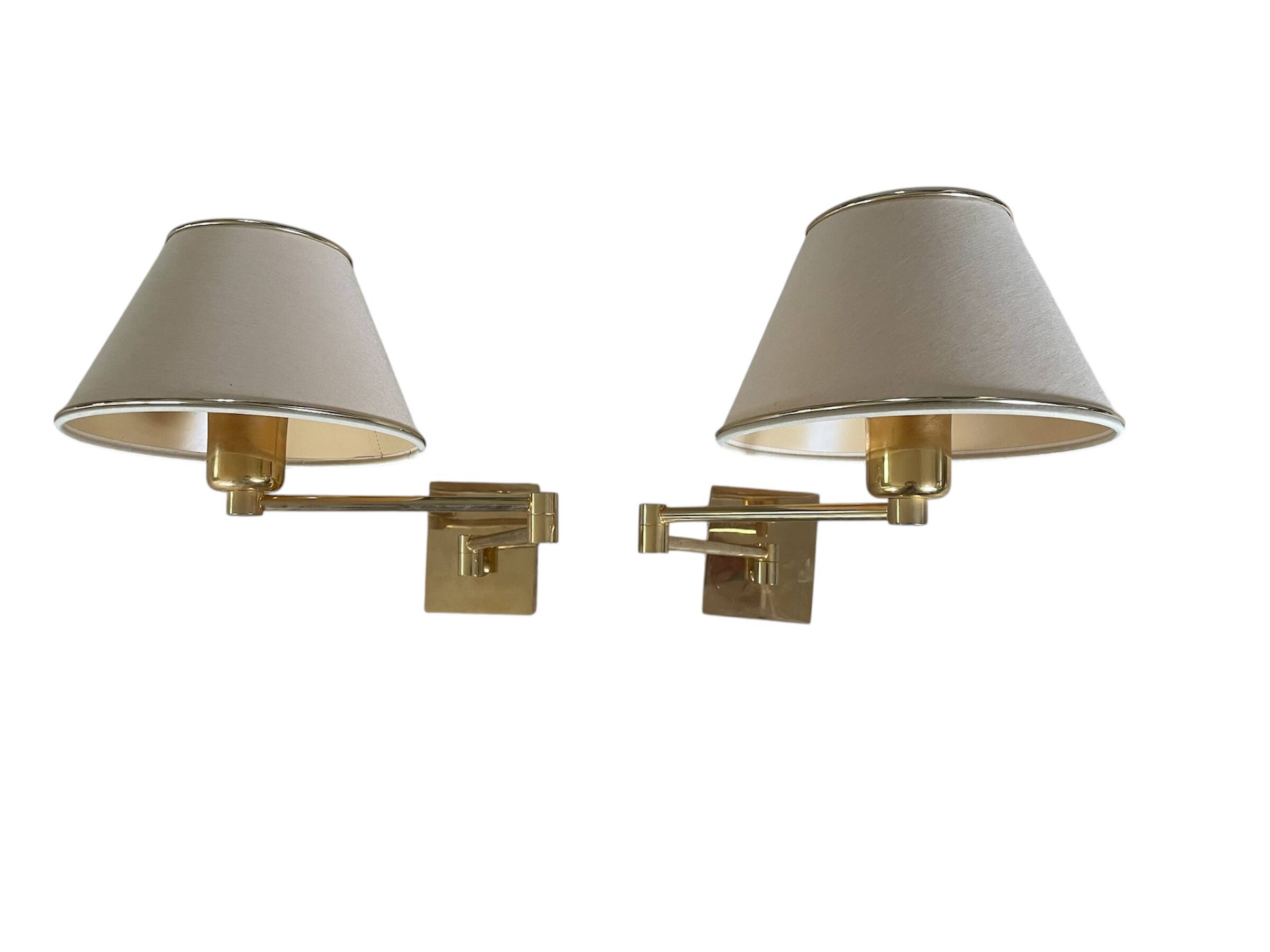 Pair of vintage brass wall lights with adjustable arms.