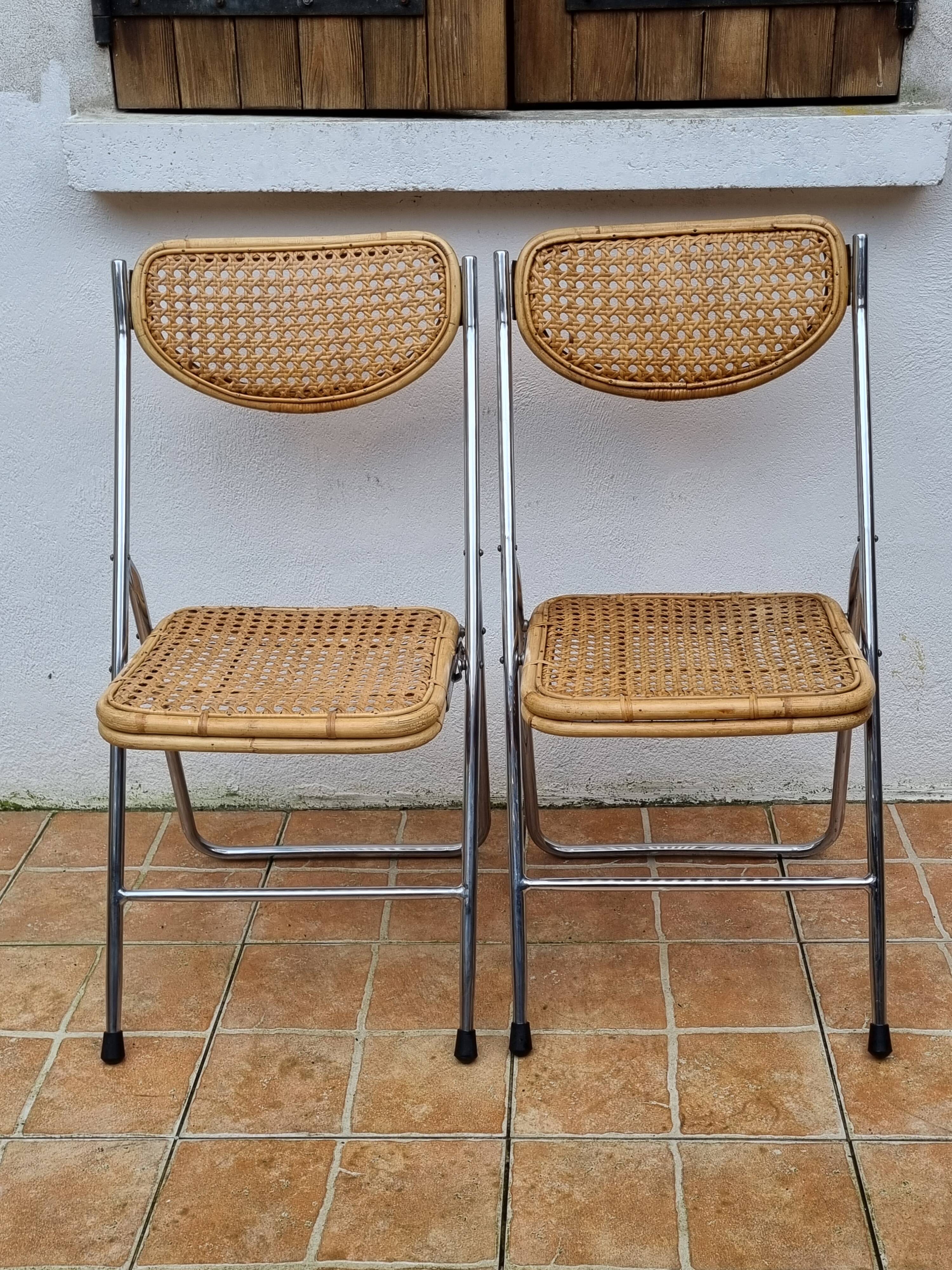 Pair of vintage metal and cane folding chairs