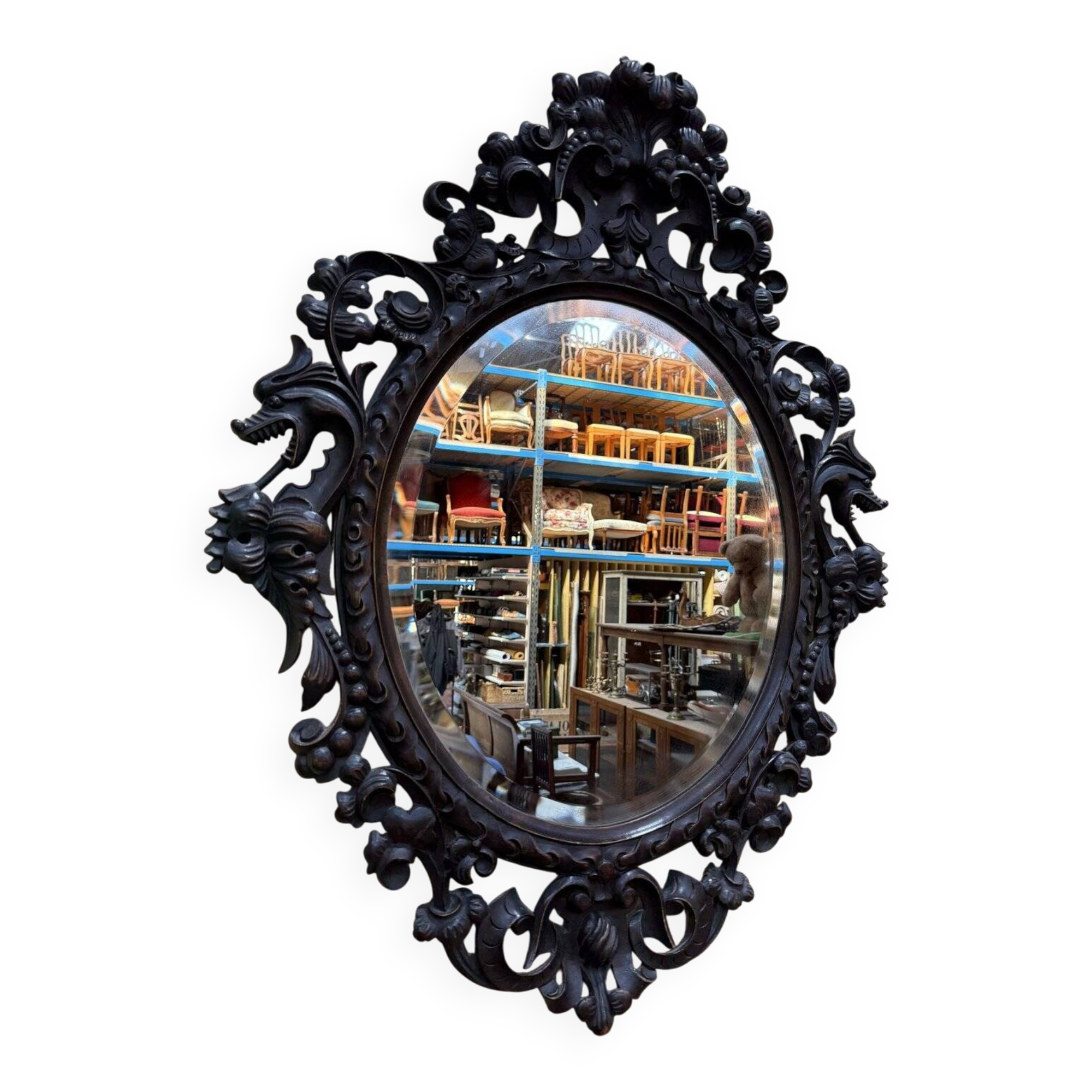 Oval mirror in carved wood with dragon heads.