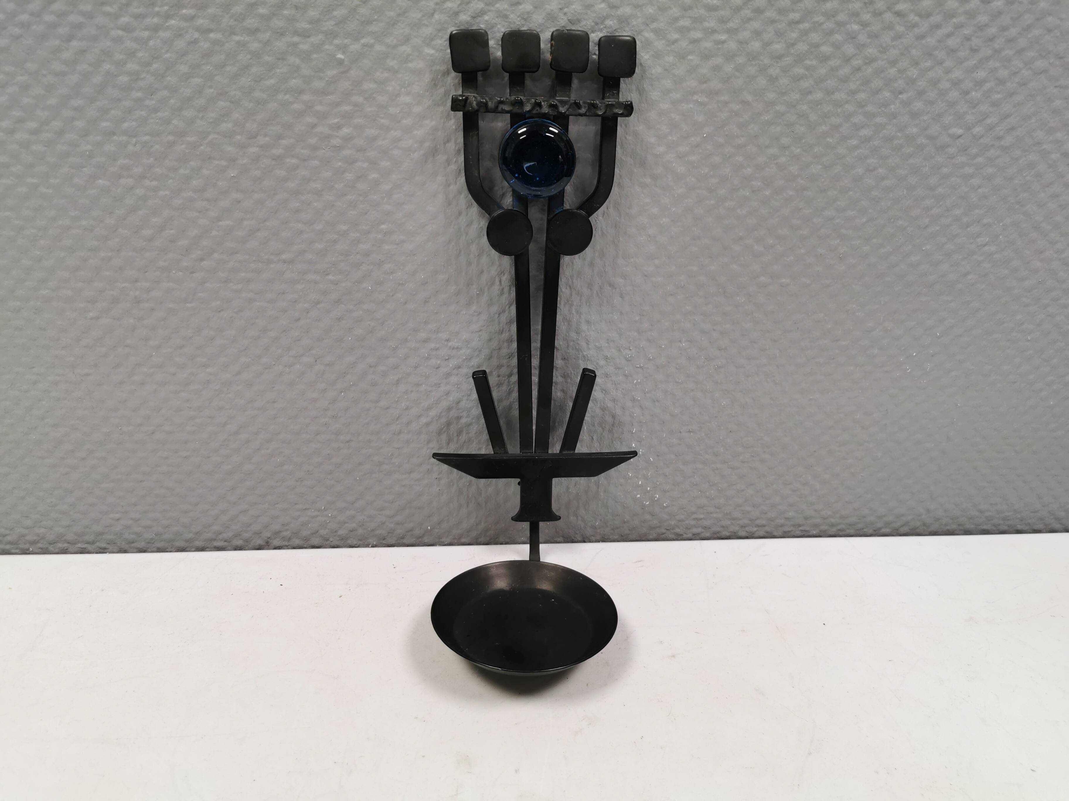 Vintage wall candle holder in wrought iron and hard pressed blue glass.