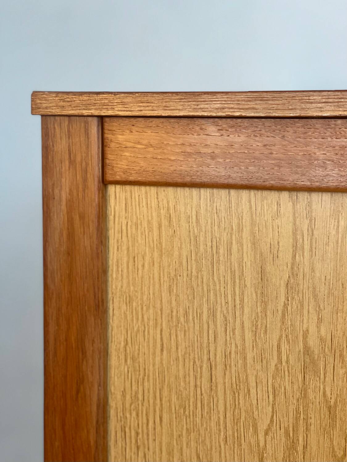 Vintage 1960s chest of drawers with covered handles.