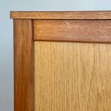 Vintage 1960s chest of drawers with covered handles.