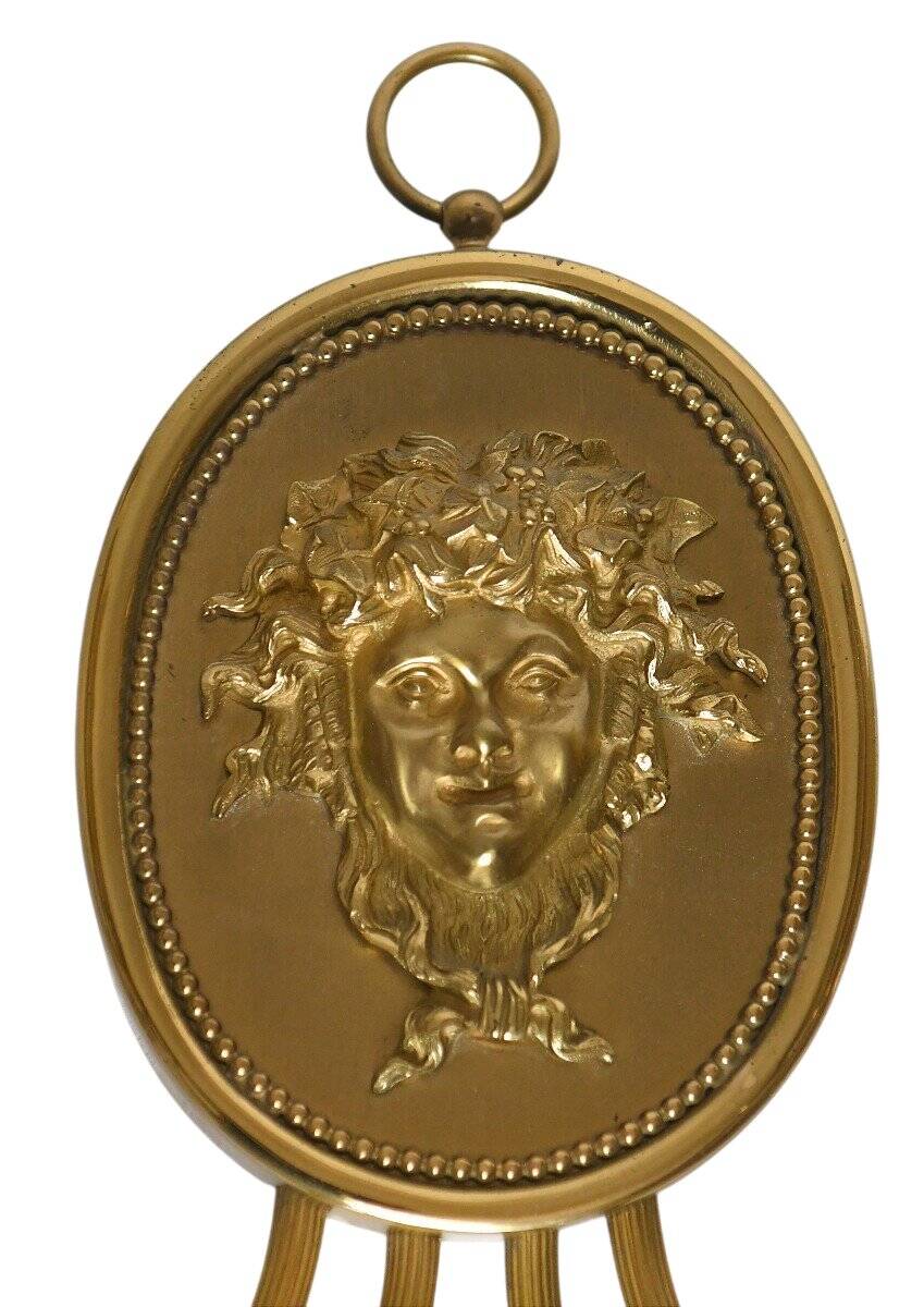 Pair of wall sconces with a relief decoration of a Bacchus mask.