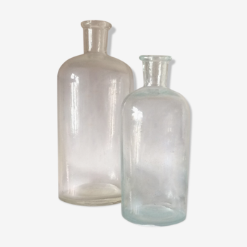 Two white glass pharmacist bottles