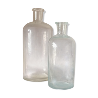 Two white glass pharmacist bottles