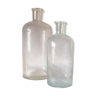 Two white glass pharmacist bottles