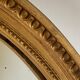 Oval mirror in carved wood, stuccoed and gilded with leaf Louis XVI style late nineteenth century