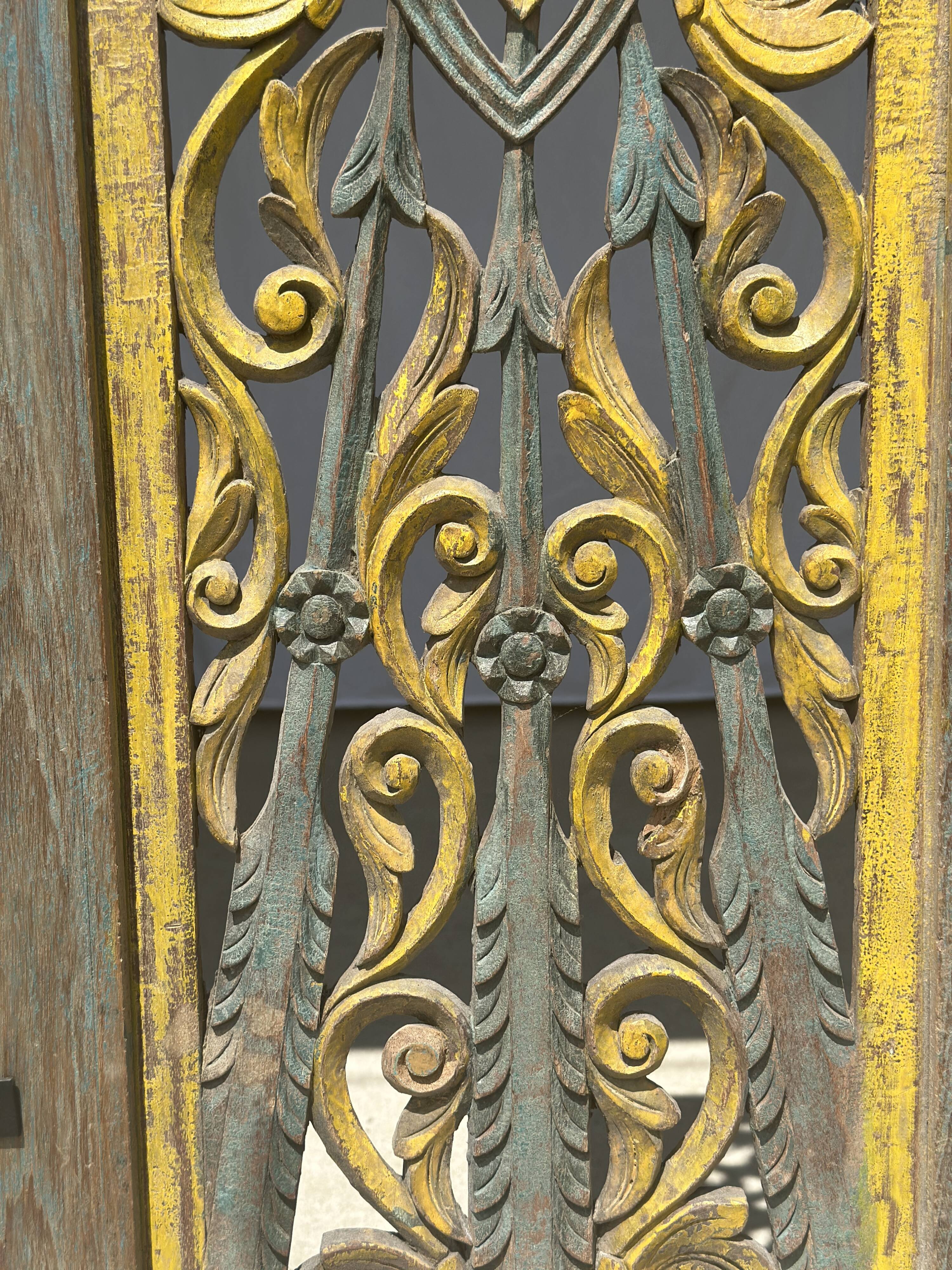 Rectangular Indonesian construction element with blue and yellow plant in carved wood