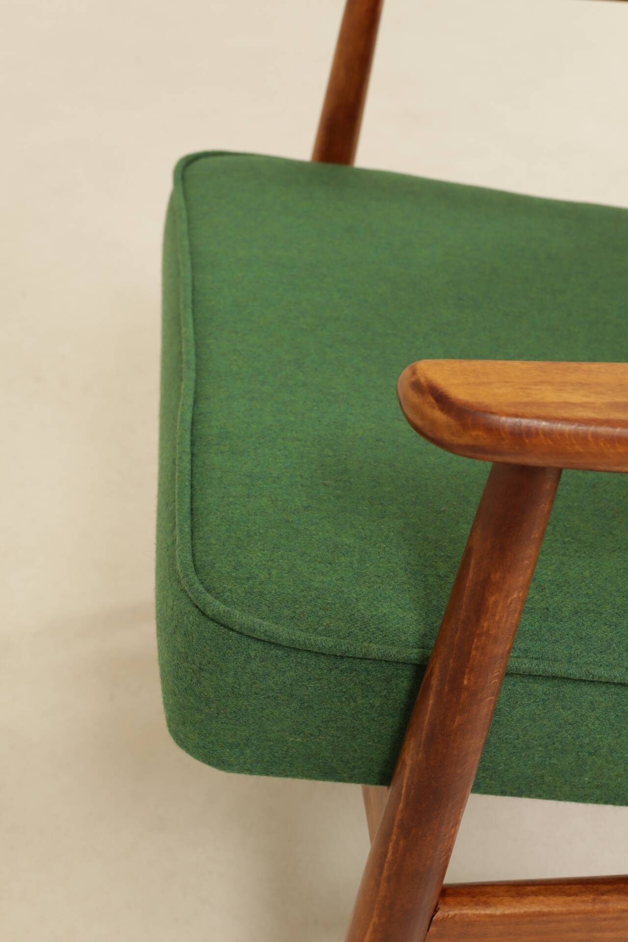 Scandinavian modern chair in green wool, vintage wooden armchair.
