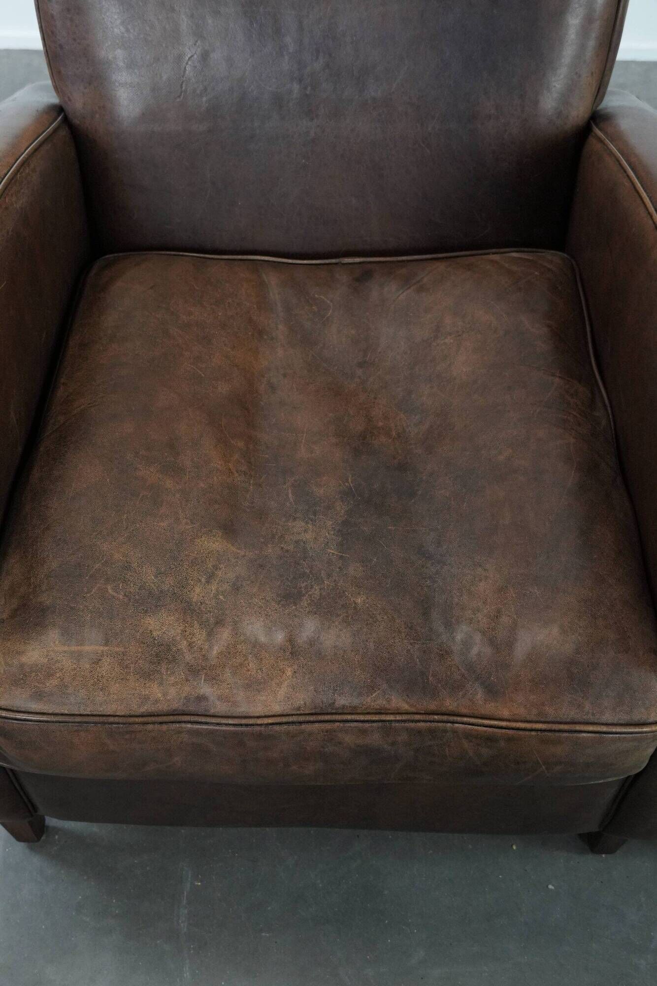 Elegant set of two sheepskin leather armchairs with beautiful round shapes