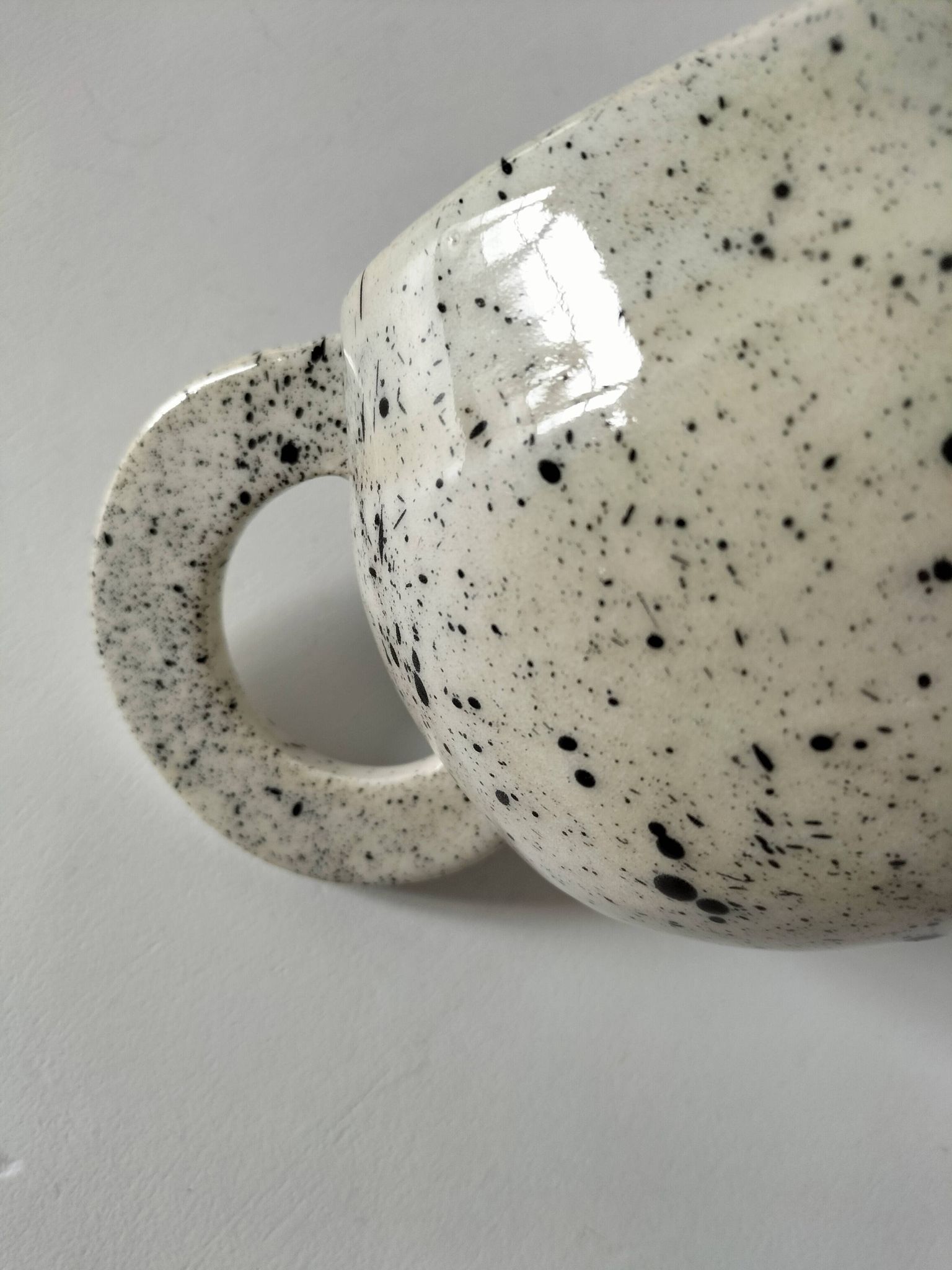 Small speckled ceramic jug in a vintage workshop style.