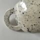 Small speckled ceramic jug in a vintage workshop style.