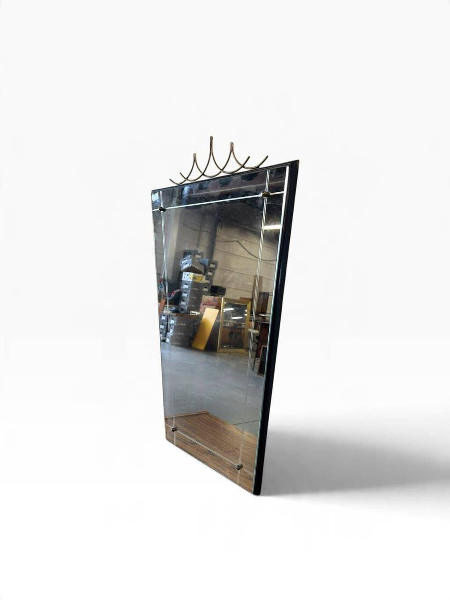 Elegant black wall mirror in vintage style with brass accents.