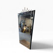 Elegant black wall mirror in vintage style with brass accents.