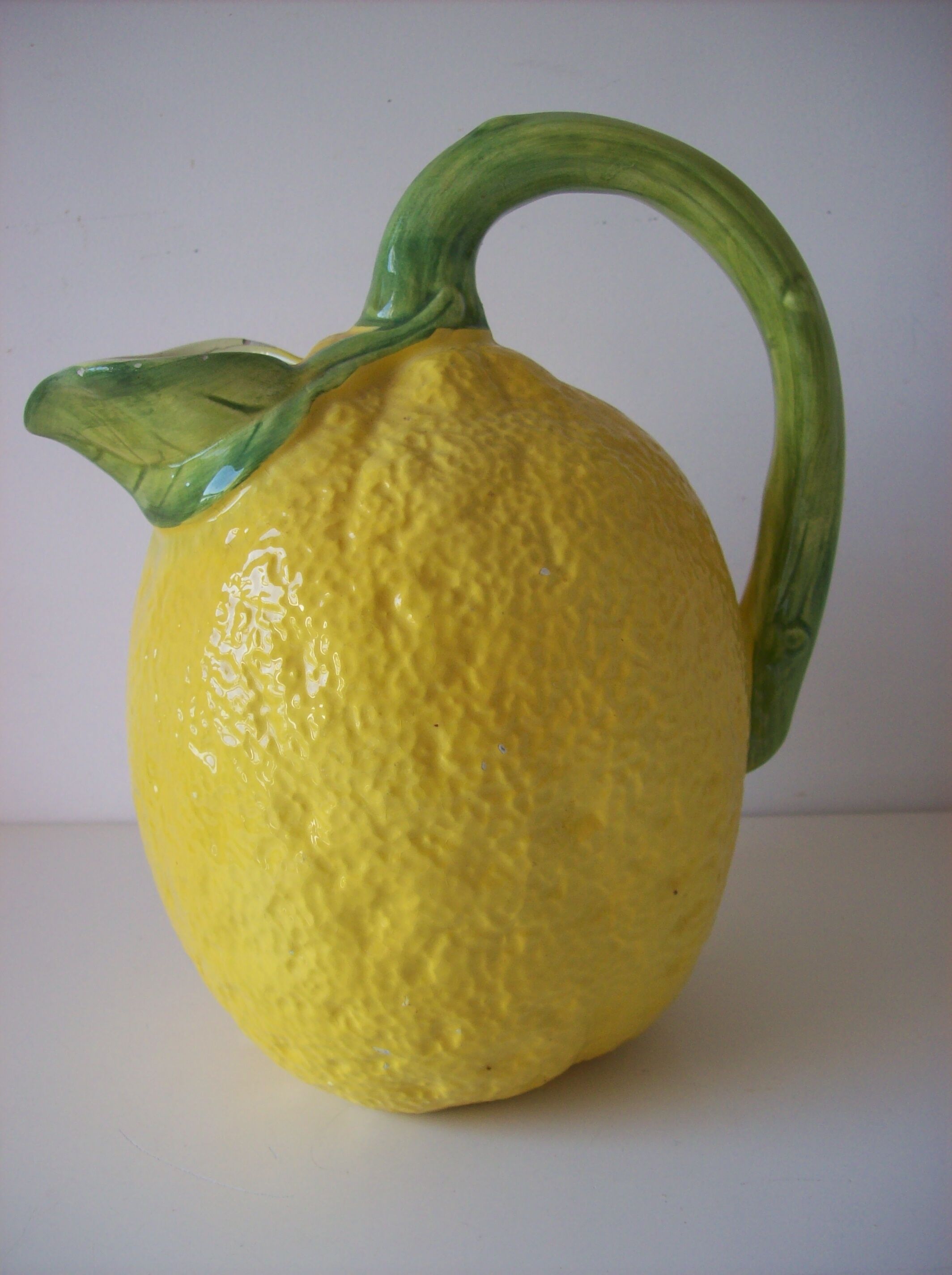 Vintage pitcher has form of lemon