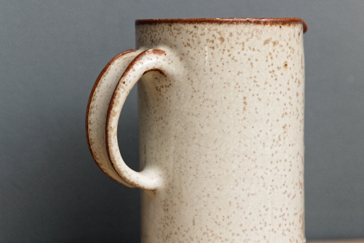 Enamelled sandstone milk jar, signed