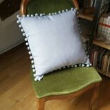 Gray cushion with pompoms