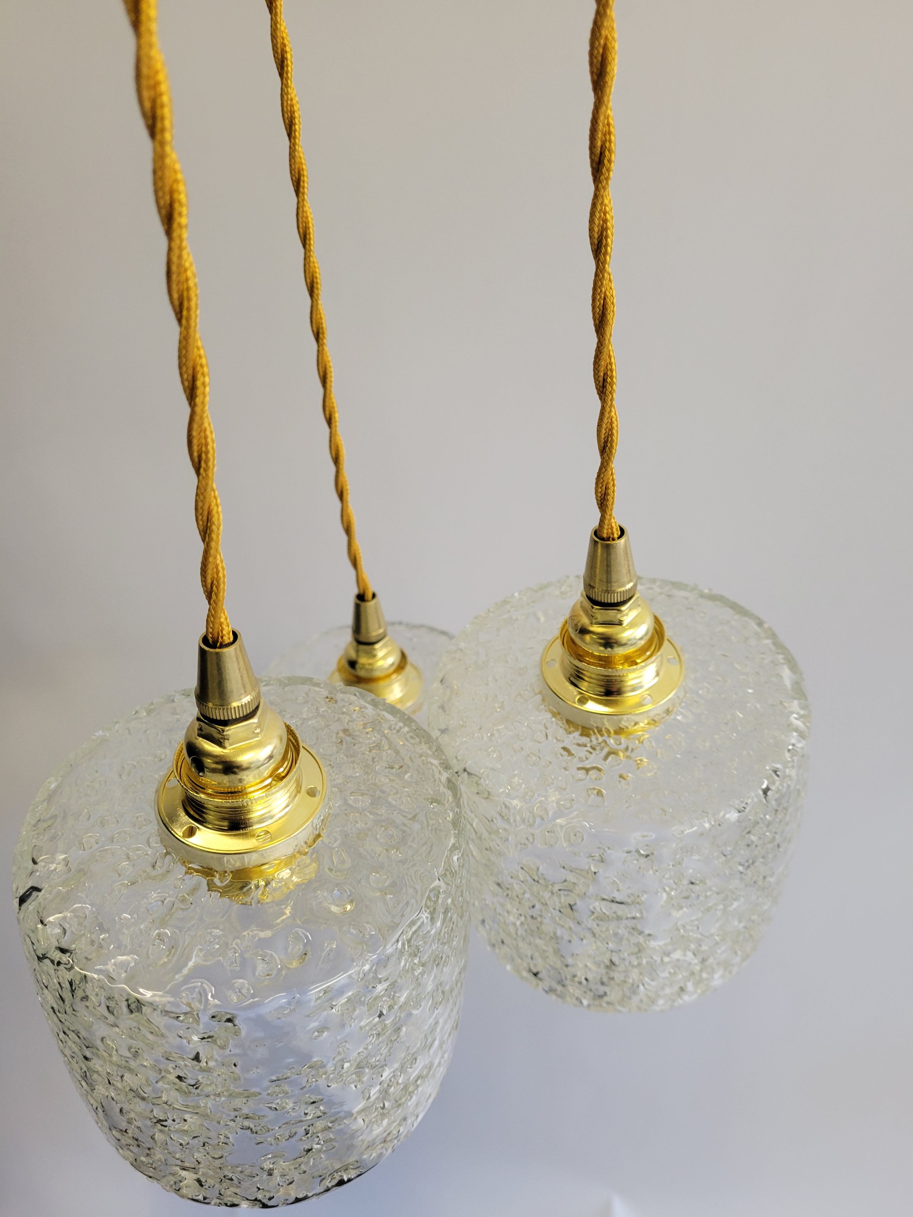 Trio of scrambled glass pendant lamps