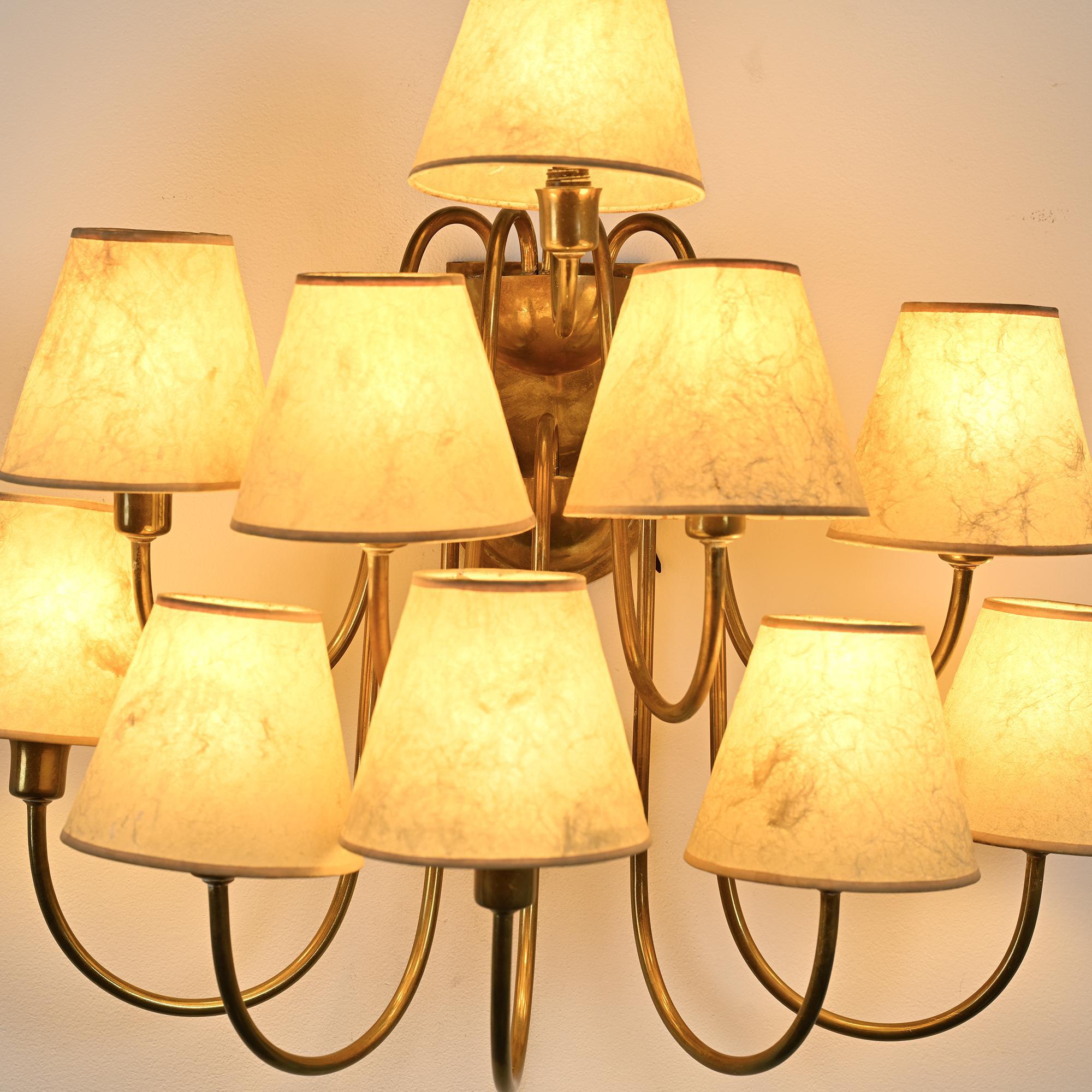 Wall sconce with nine arms in brass, France, circa 1950.