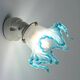 Pair of wall lights with porcelain feet and blue glass tulips in Art Deco style.