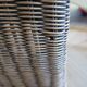 2 armchairs in woven rattan and wood, 1980s