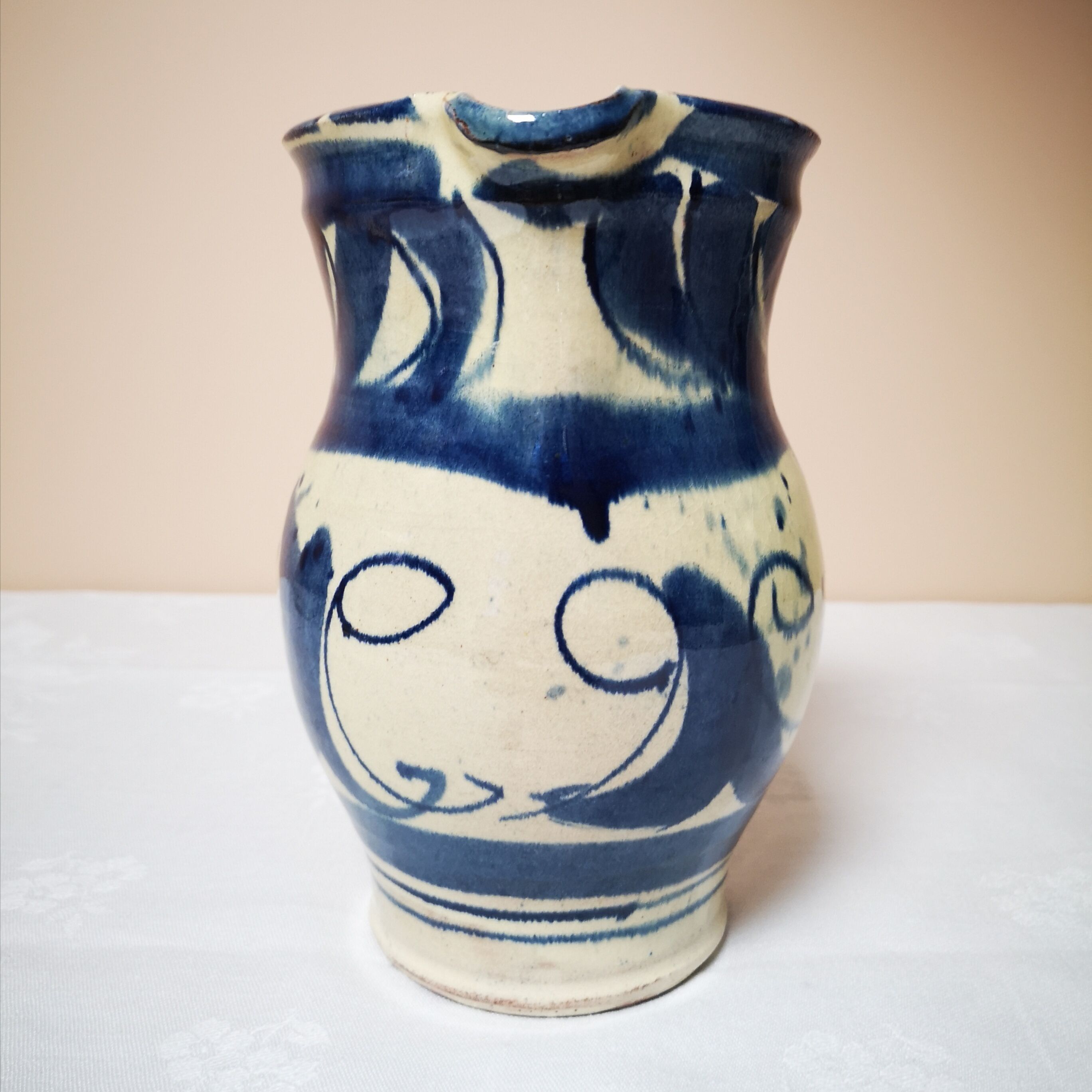 Enamelled ceramic blue pitcher signed by the artist