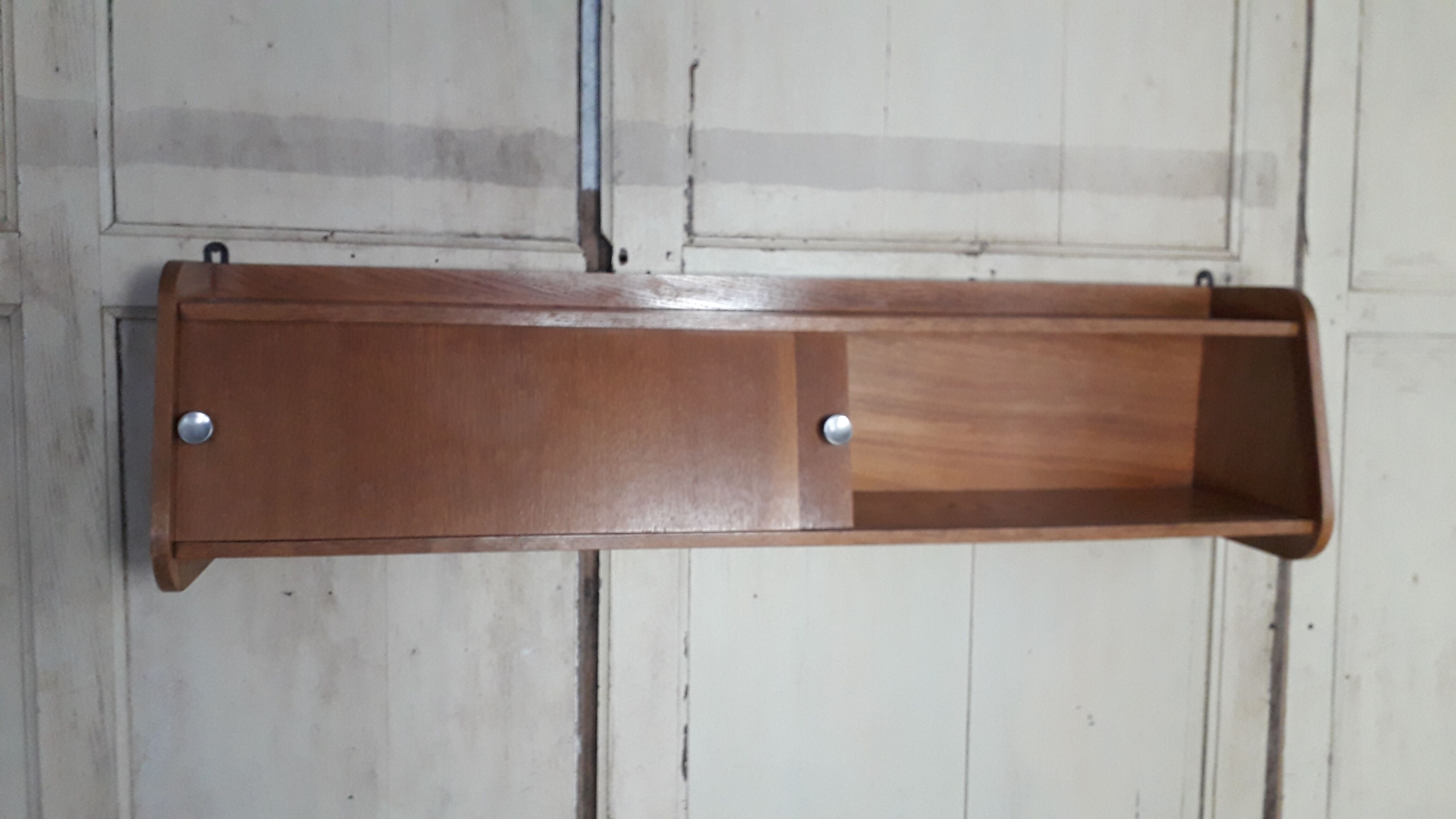 Wall shelf with sliding doors