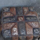 Set of 2 vintage ottomans in brown and black leather with Egyptian patterns from the 1970s.