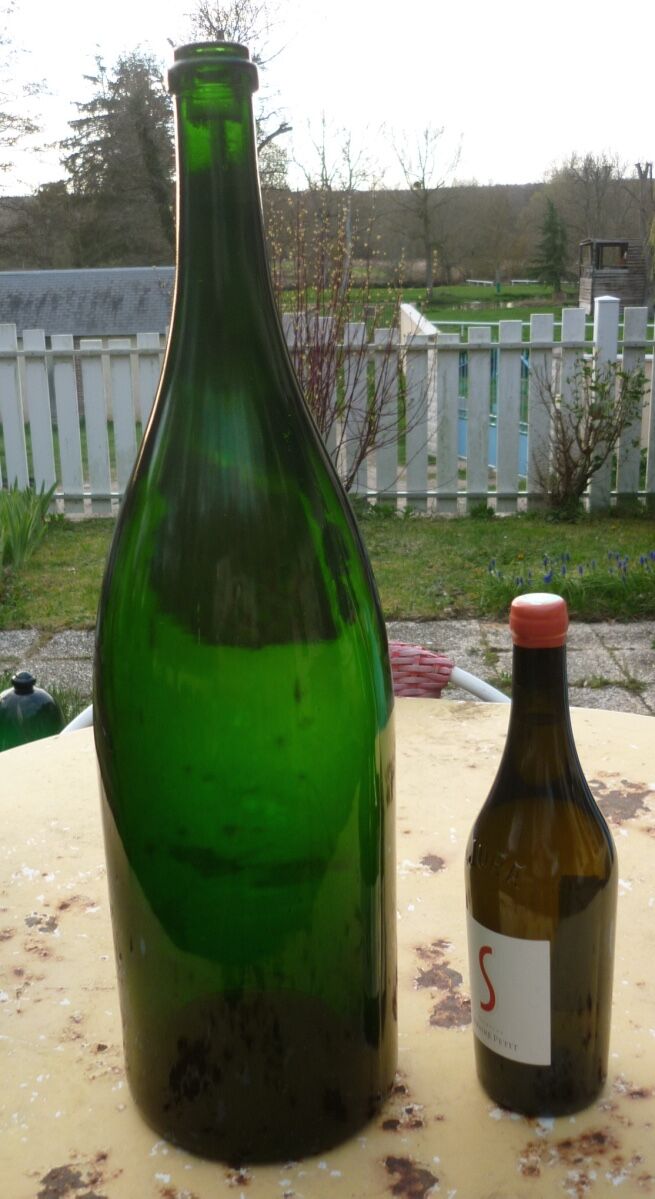 Green blown glass bottle of 58 cm.