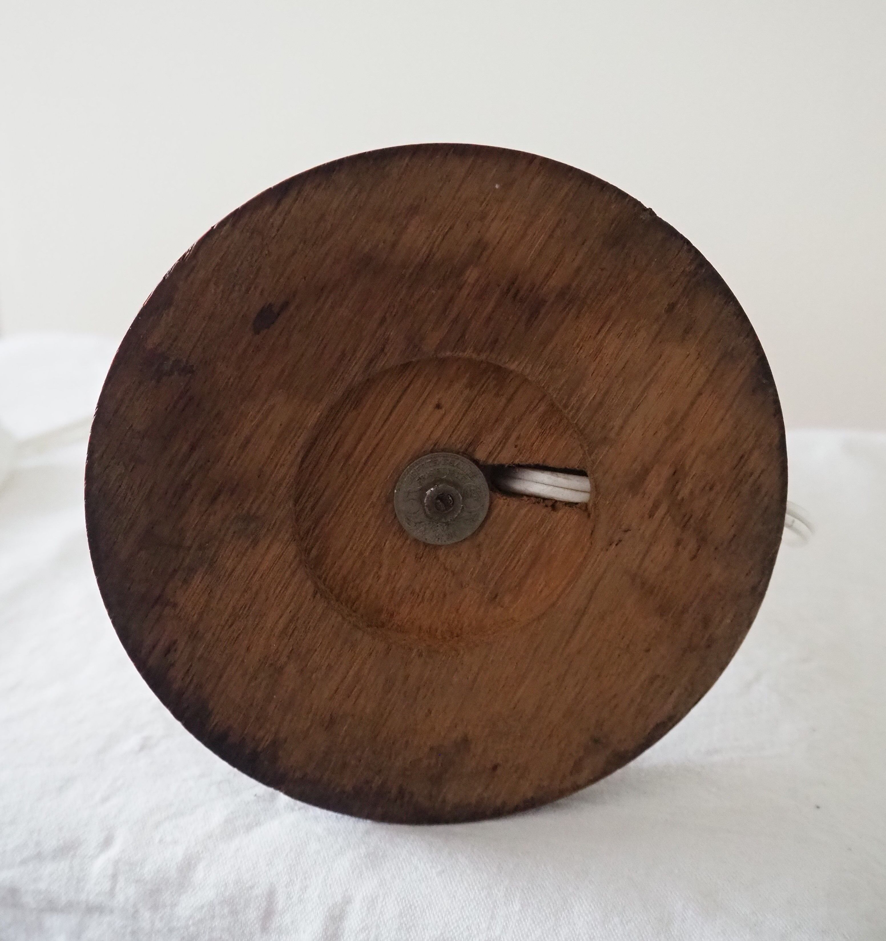 Table lamp for bedside use in earthenware with a wooden base.