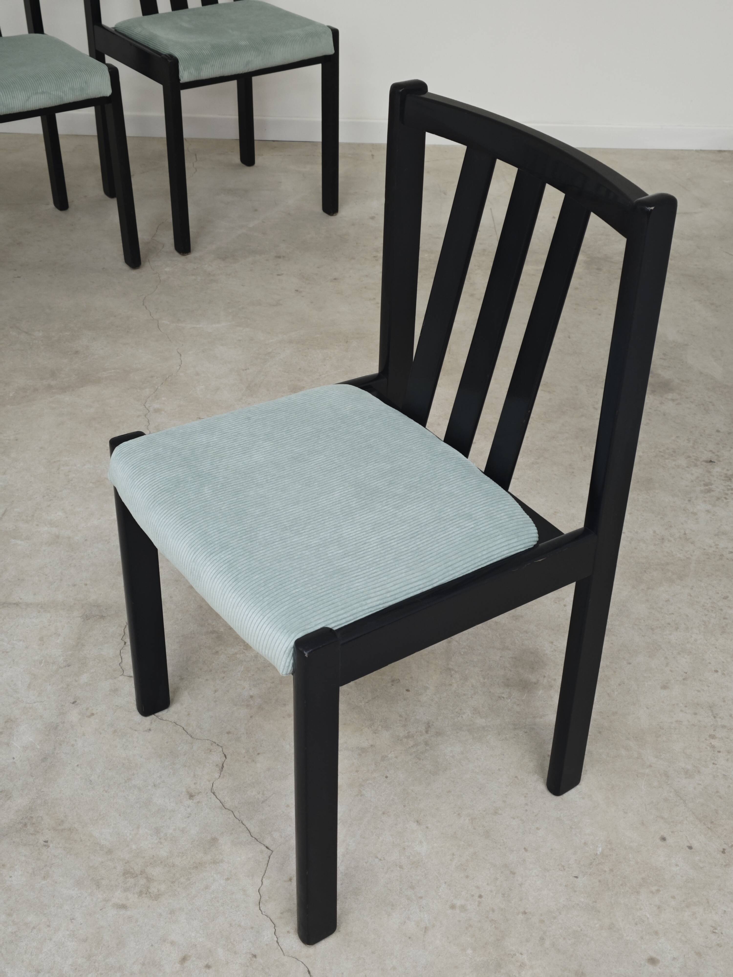 Set of 6 modernist black chairs with light blue-green ribbed fabric.