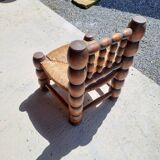 Low chair 50s oak and straw by the fire
