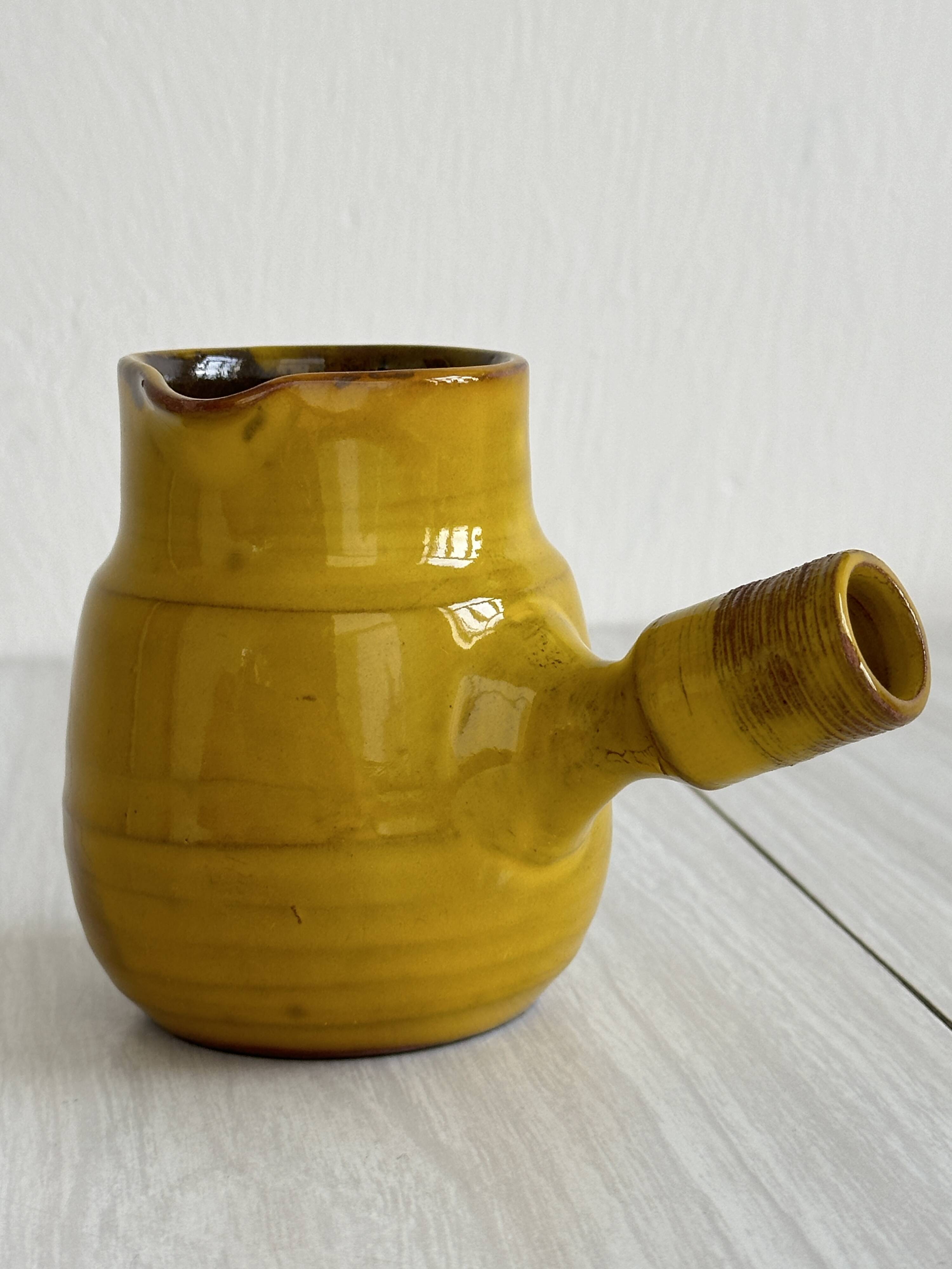 Yellow glazed ceramic sauce boat or milk jug