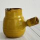 Yellow glazed ceramic sauce boat or milk jug