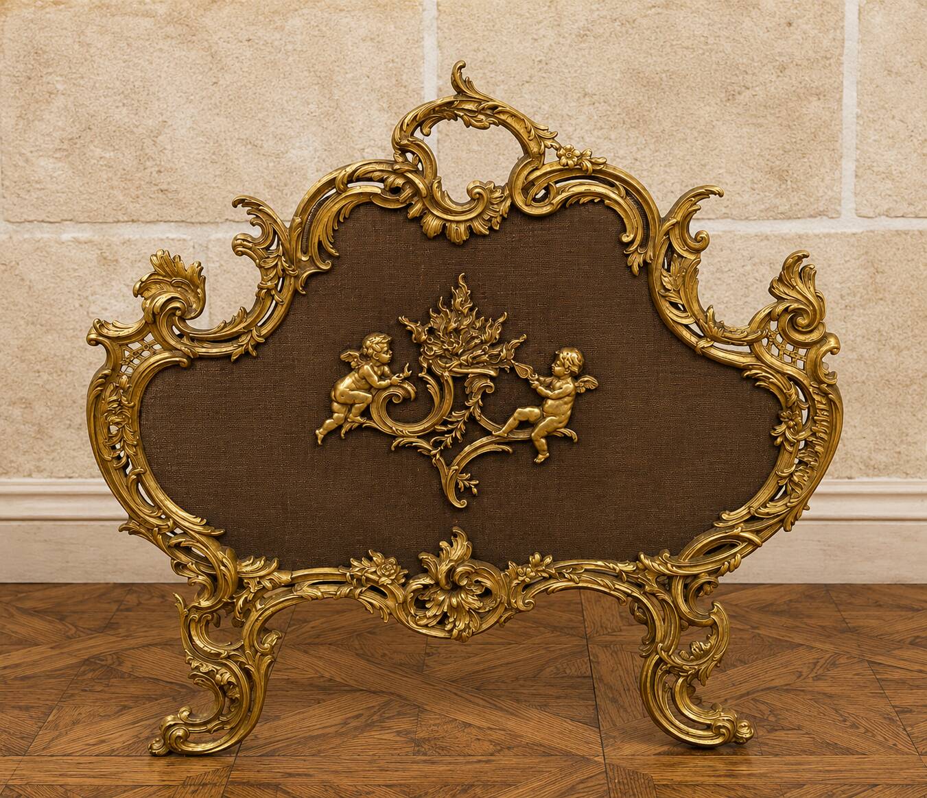 Large gilded bronze fireplace screen decorated with putti and rocaille motifs.