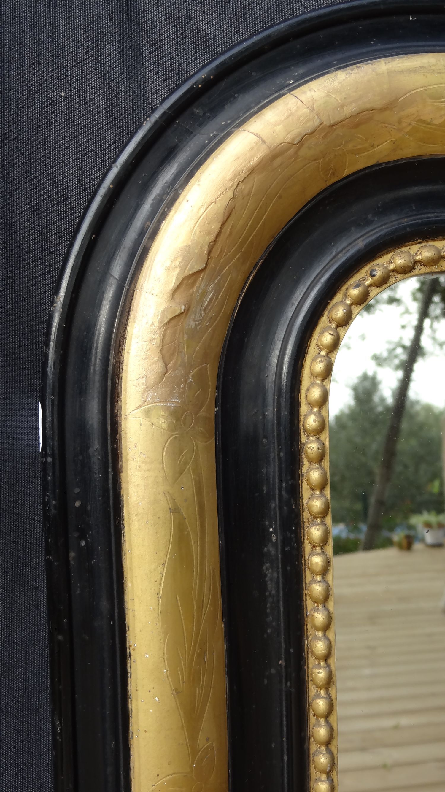 Louis Philippe mirror in blackened and gilded wood, 74 x 102 cm