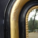 Louis Philippe mirror in blackened and gilded wood, 74 x 102 cm