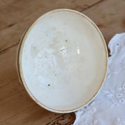 Old ivory ceramic bowl with double green trim.
