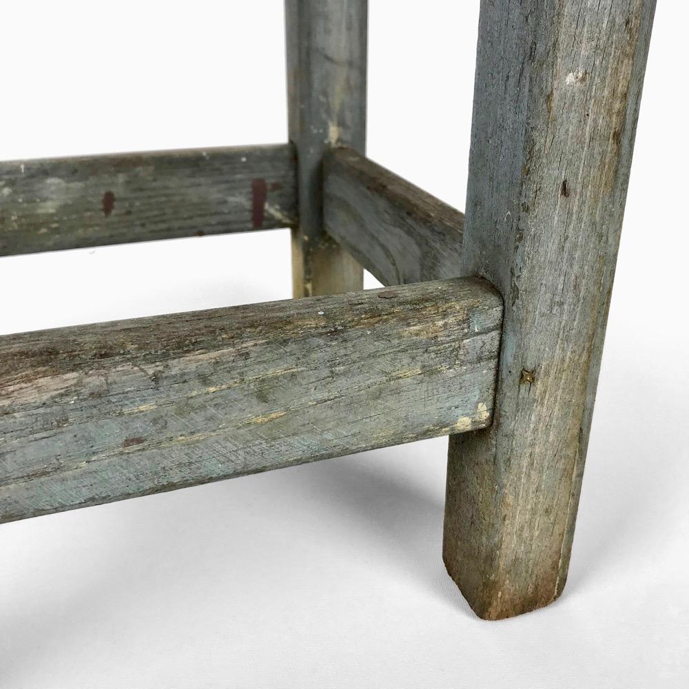 Blue-tinted wooden workshop stool