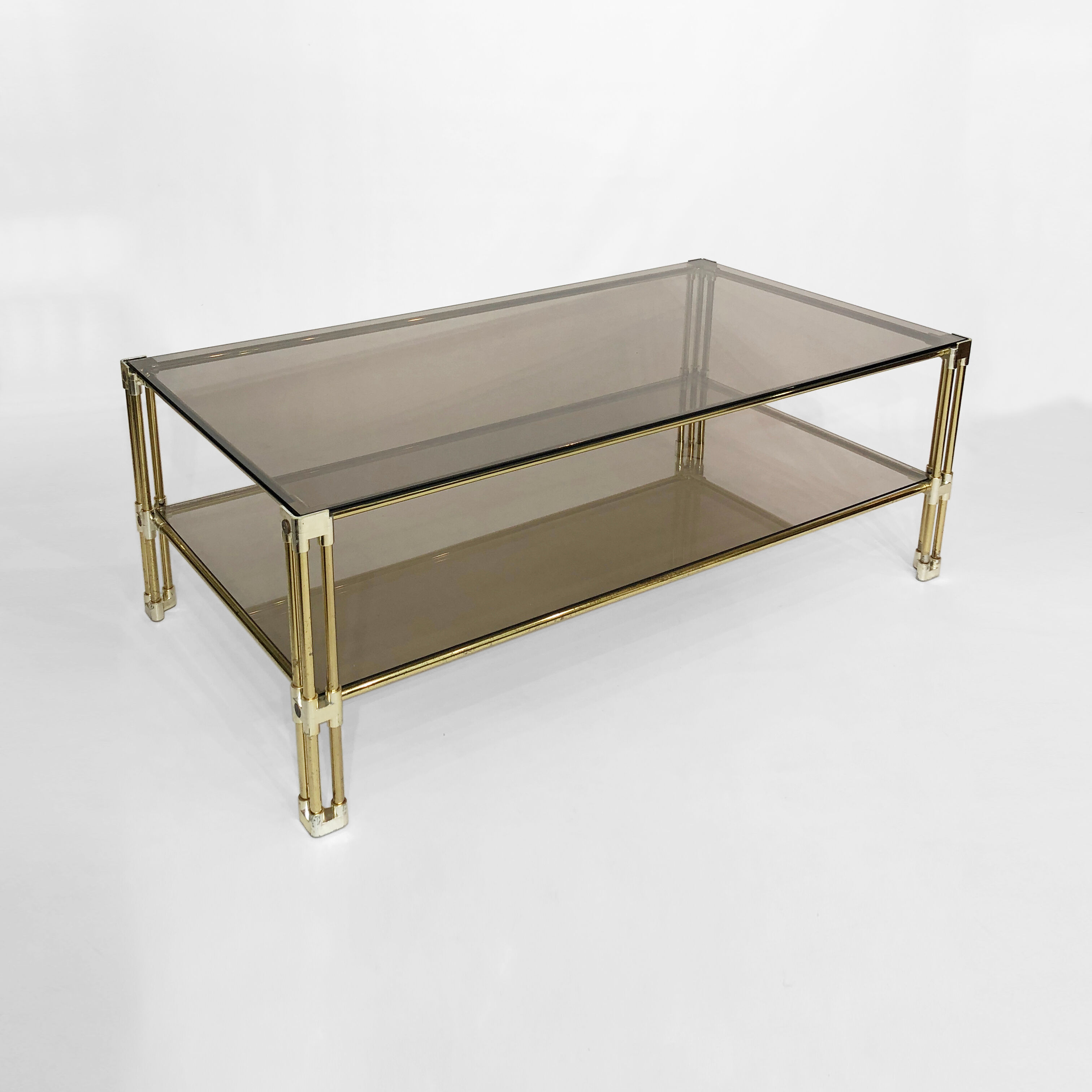 Brass two-tiered coffee table hollywood regency gold smoked glass 1970s