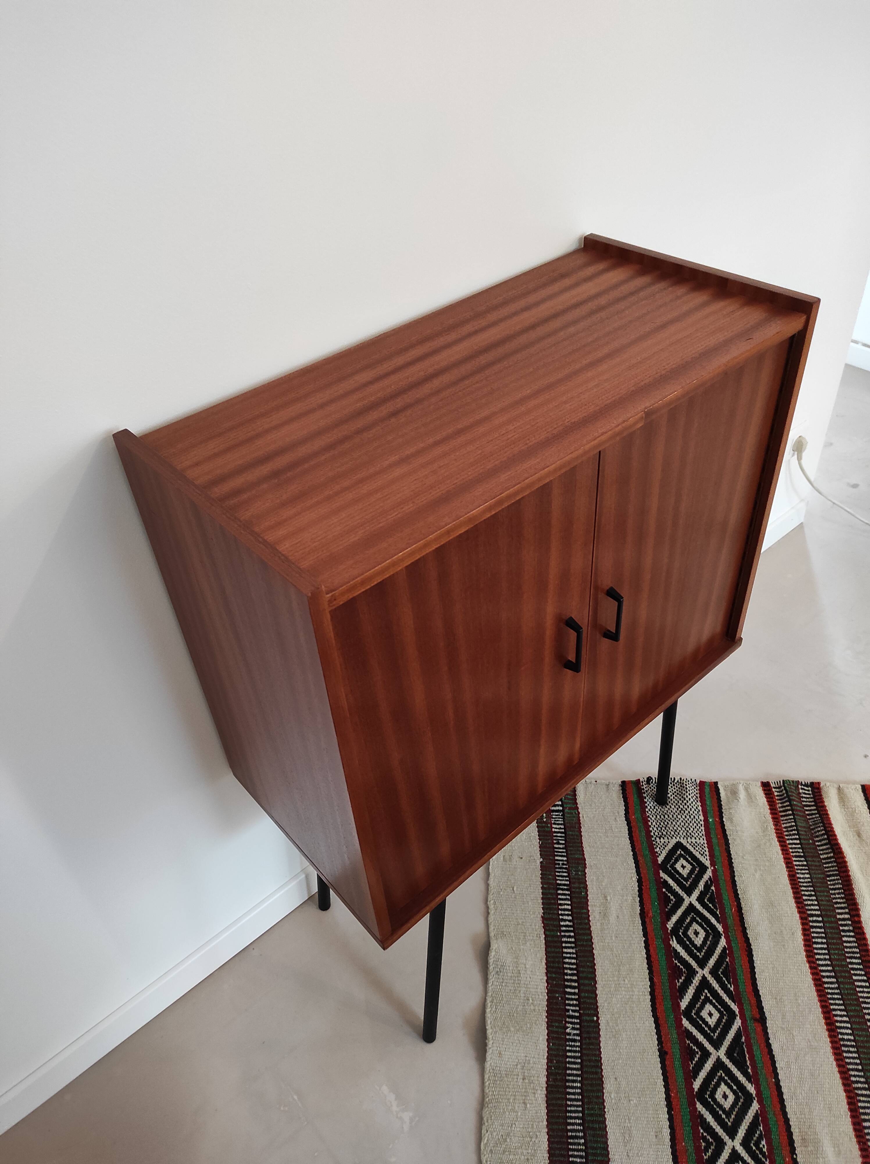 Piece of furniture on high feet metal compass