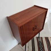 Piece of furniture on high feet metal compass