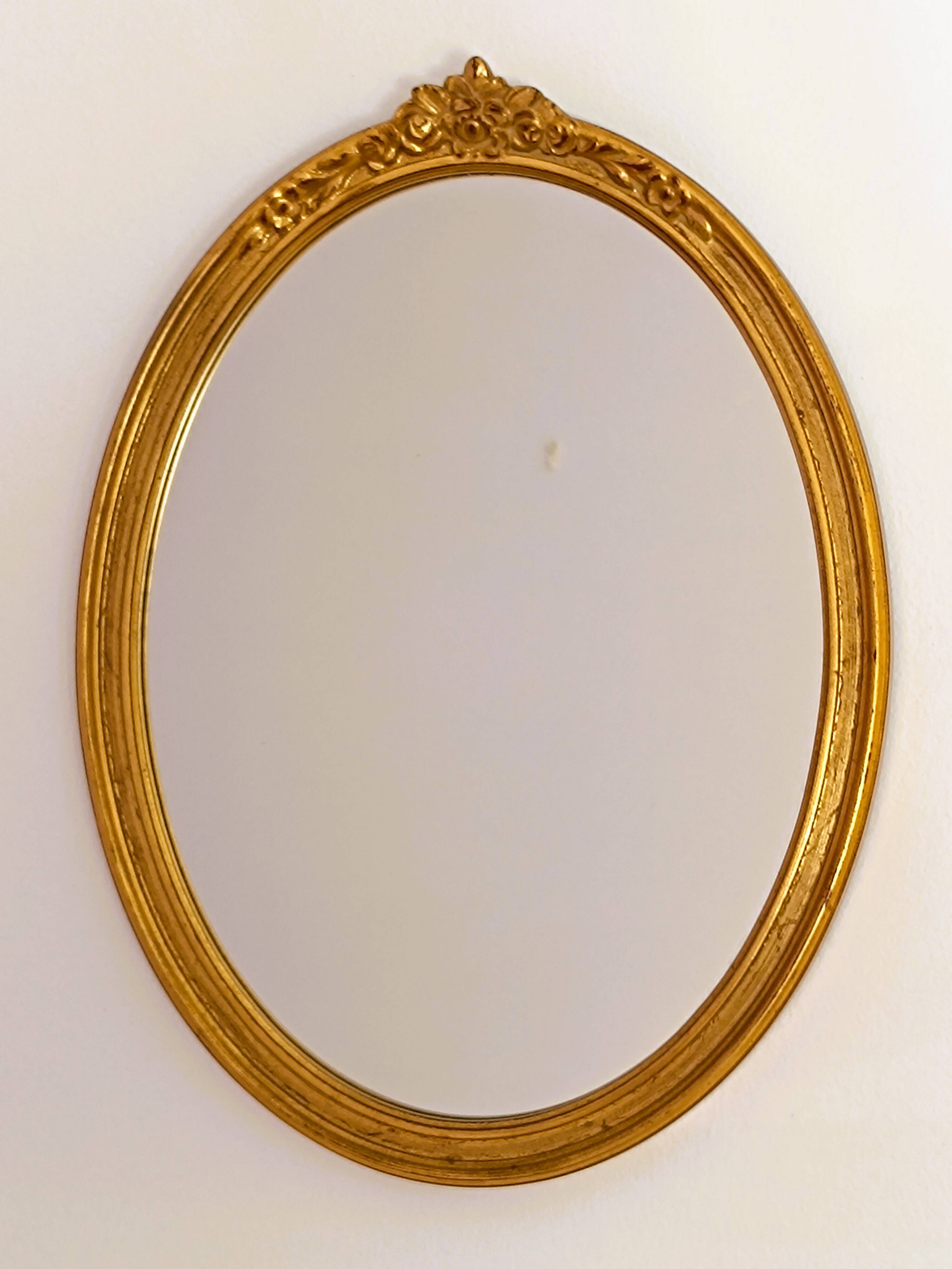 Antique oval-shaped gilded mirror